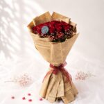Crimson Sky red rose bouquet with baby's breath wrapped in kraft paper, Bangalore flower delivery