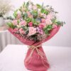Premium pink rose and eustoma bouquet with baby’s breath and eucalyptus wrapped in blush fabric by FreshKnots Bangalore with same day delivery.