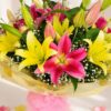 Yellow and pink lily bouquet wrapped in pastel paper – same-day exotic flower delivery in Bangalore by FreshKnots