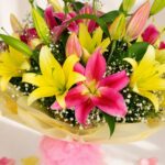 Yellow and pink lily bouquet wrapped in pastel paper – same-day exotic flower delivery in Bangalore by FreshKnots