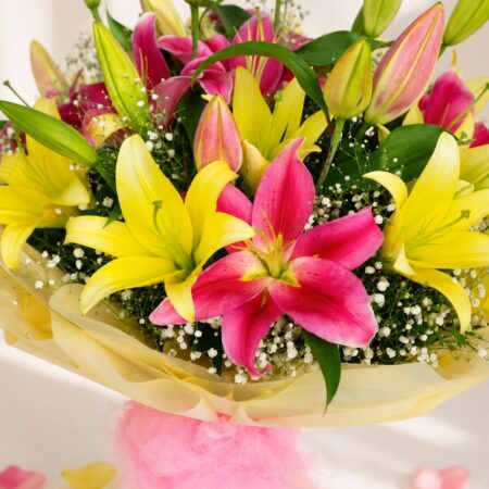 Yellow and pink lily bouquet wrapped in pastel paper – same-day exotic flower delivery in Bangalore by FreshKnots