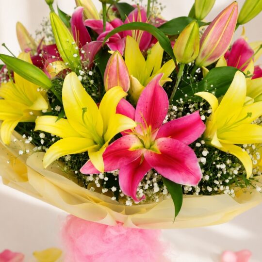 Yellow and pink lily bouquet wrapped in pastel paper – same-day exotic flower delivery in Bangalore by FreshKnots