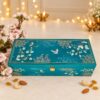 Cashews, raisins and almonds in three teal bird-print tins with the open Firoza gift box