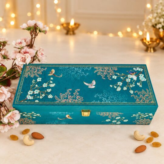 Cashews, raisins and almonds in three teal bird-print tins with the open Firoza gift box