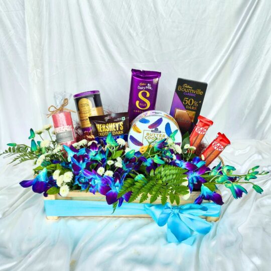 Hamper of chocolates, cookies, candles and flowers