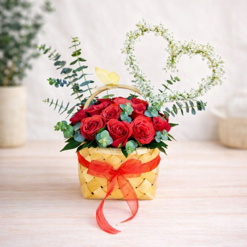 Red rose basket arrangement with heart design for same day flower delivery Bangalore by premium florist.