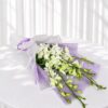 White orchid bouquet in lilac wrap for same day flower delivery Bangalore