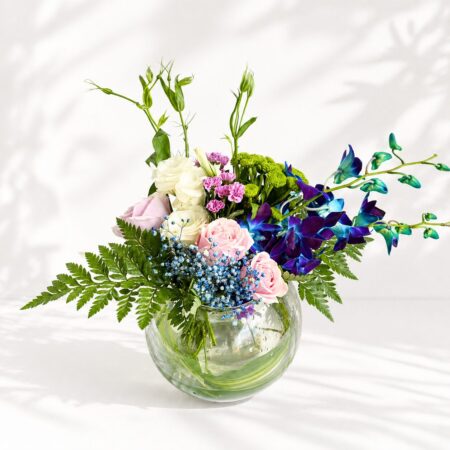 Exotic fishbowl flower arrangement with blue orchids, pink roses, and eustoma – same-day delivery in Bangalore by FreshKnots