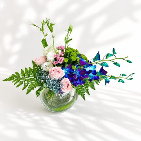 Exotic fishbowl flower arrangement with blue orchids, pink roses, and eustoma – same-day delivery in Bangalore by FreshKnots