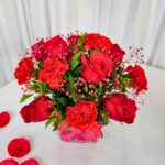 Red Roses and carnations in a glass vase