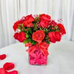 Red Roses and carnations in a glass vase