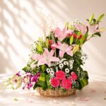 Pink lily flower basket with orchids, carnations and daisies for same day flower delivery in Bangalore