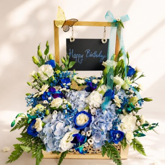 Blue hydrangea birthday floral arrangement Bangalore with roses orchids and luxury flower setup