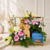 Luxury floral gift hamper with lilies, carnations, chocolates, almonds and gourmet treats in a gold tray for gifting in Bangalore.