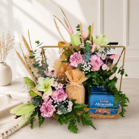 Luxury floral gift hamper with lilies, carnations, chocolates, almonds and gourmet treats in a gold tray for gifting in Bangalore.