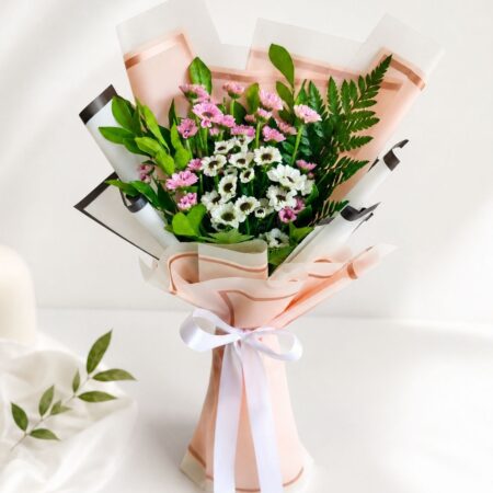 Colorful mixed flower bouquet with roses and fresh seasonal blooms wrapped in elegant pastel packaging for flower delivery in Bangalore.