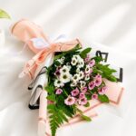 Colorful mixed flower bouquet with roses and fresh seasonal blooms wrapped in elegant pastel packaging for flower delivery in Bangalore.