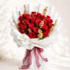 Luxury red rose bouquet with golden eucalyptus accents and premium wrapping for anniversary and birthday flower delivery in Bangalore.