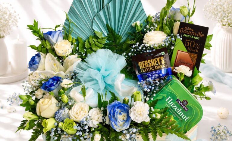 Luxury cake and flower hamper with fresh flowers and gourmet treats for premium gifting in Bangalore.