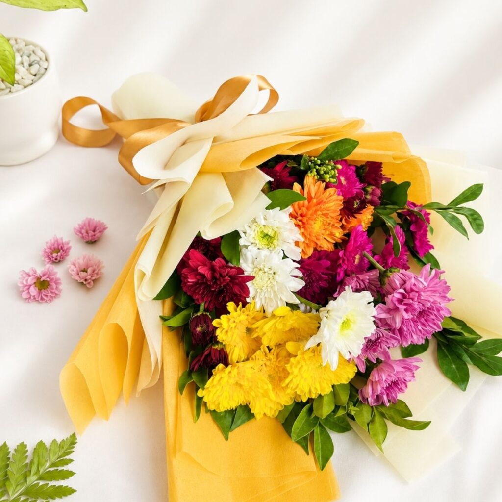 Cheerful daisy bouquet with fresh white and yellow blooms wrapped in elegant pastel packaging for flower delivery in Bangalore.