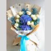 Blue hydrangea and white rose bouquet with baby’s breath, wrapped in polka dot paper – same day flower delivery in Bangalore
