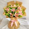 Pink lily bouquet wrapped in jute with green foliage – perfect for birthday gifts, anniversary flowers, and same day flower delivery in Bengaluru.
