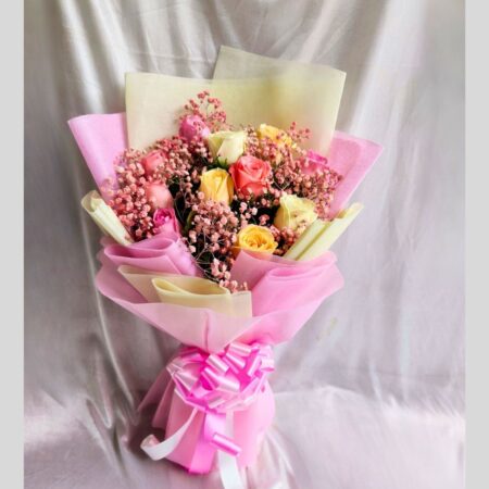 FreshKnots mixed rose bouquet with pink, yellow, and cream roses wrapped in designer paper – available for same day flower delivery in Bengaluru.