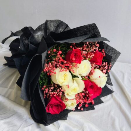 Elegant red and white rose bouquet with pink fillers in black wrapping – Bangalore flower delivery