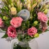 Vase arrangement featuring eustoma, tuberose, and mixed greens in a clear glass vase.
