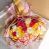 A vibrant mixed rose bouquet with pink, yellow, and white roses, elegantly wrapped in blush and gold paper with a satin bow — available for same day flower delivery in Bangalore.