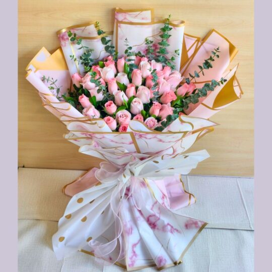 Elegant bouquet of blush pink roses in premium artistic wrapping
