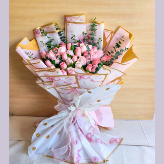 Elegant bouquet of blush pink roses in premium artistic wrapping