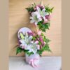 A pastel floral arrangement in a glass vase featuring white hydrangeas, yellow and pink roses, white daisies, and pink fillers, tied with a white ribbon — ideal for same day flower delivery in Bangalore.