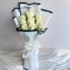 A bouquet of fresh white roses wrapped in elegant white paper with a satin bow — available for same day flower delivery in Bangalore.