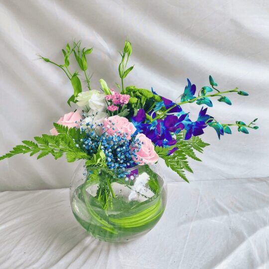 Exotic fishbowl flower arrangement with blue orchids, pink roses, and eustoma – same-day delivery in Bangalore by FreshKnots