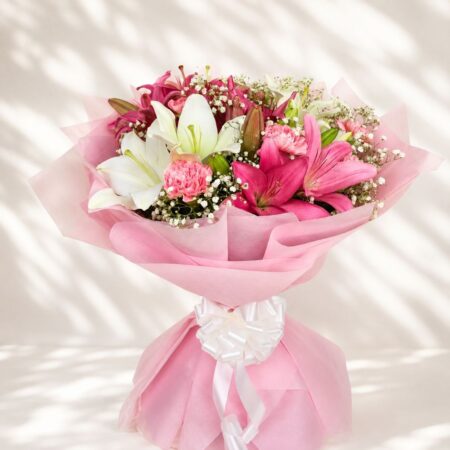 Luxury bouquet of pink lilies and carnations with elegant wrapping for premium flower delivery in Bangalore.