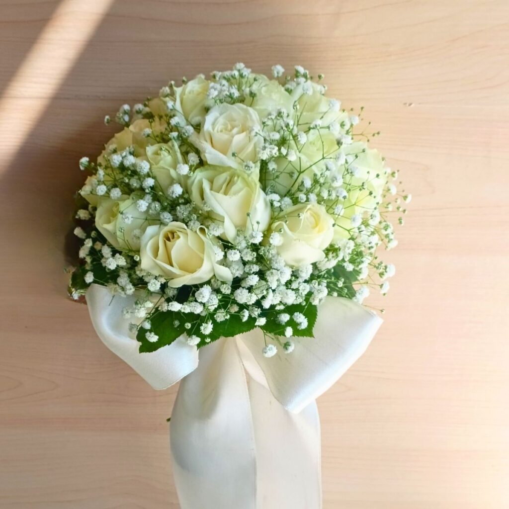 Elegant white rose bridal bouquet with baby’s breath — same-day delivery in Bangalore.
