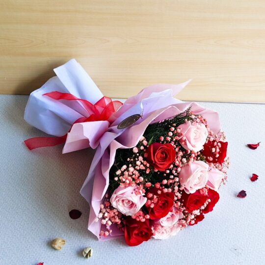 Pink and red roses bouquet wrapped in pastel paper with a red ribbon, Fresh Knots romantic flower bouquet for gifting and same-day delivery in Bangalore.