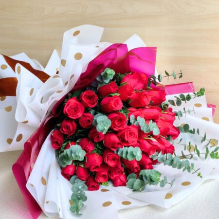 Fresh red rose bouquet with eucalyptus greens, flower delivery in Bangalore by FreshKnots.