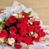 Red rose bouquet with golden accents and white polka-dot wrapping – premium romantic flowers by FreshKnots, same-day delivery in Bangalore.