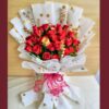 Red rose bouquet with golden accents and white polka-dot wrapping – premium romantic flowers by FreshKnots, same-day delivery in Bangalore.