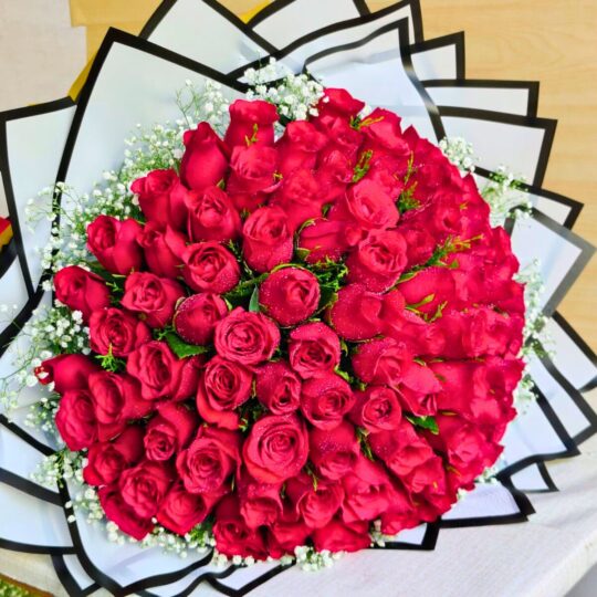 Luxury bouquet of 100 fresh red roses with white fillers, handcrafted by FreshKnots Bangalore.