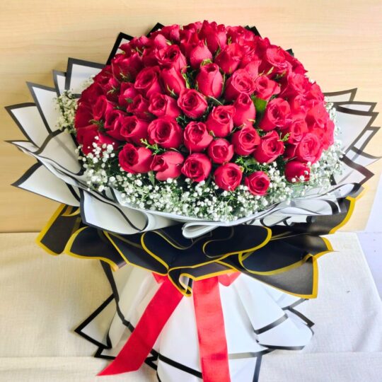 Luxury bouquet of 100 fresh red roses with white fillers, handcrafted by FreshKnots Bangalore.