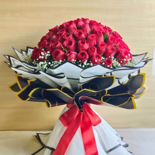 Luxury bouquet of 100 fresh red roses with white fillers, handcrafted by FreshKnots Bangalore.