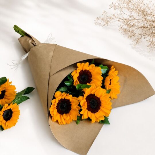Fresh sunflower bouquet wrapped in brown kraft paper by premium florist in Bangalore