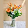 Birds of paradise and lily flower arrangement in glass vase with same day delivery in Bangalore