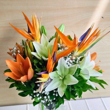 Birds of paradise and lily flower arrangement in glass vase with same day delivery in Bangalore