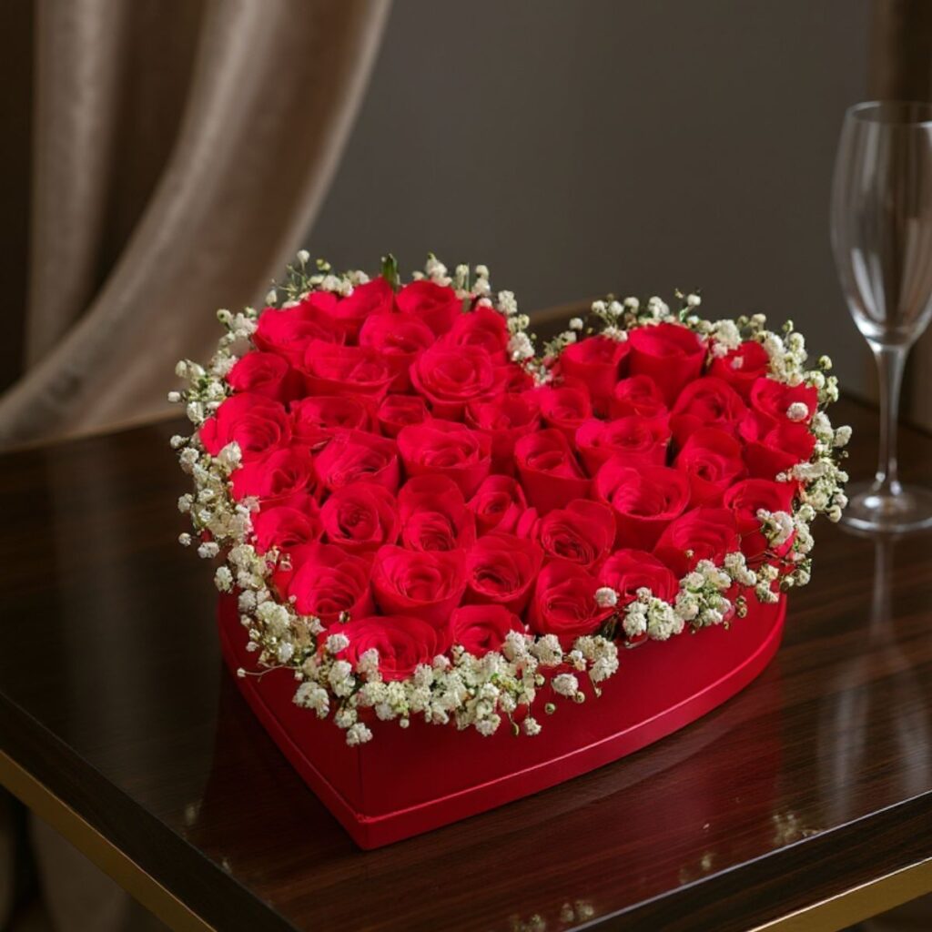 Heart-shaped red rose box with baby’s breath for romantic gifting - FreshKnots same-day flower delivery in Bangalore.