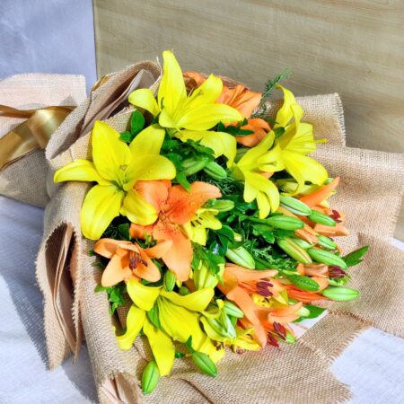 Fresh yellow and orange lily bouquet in jute wrap for same day flower delivery in Bangalore by FreshKnots