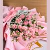 Soft pink rose bouquet with baby’s breath and delicate fillers, wrapped in pastel pink paper for an elegant floral gift